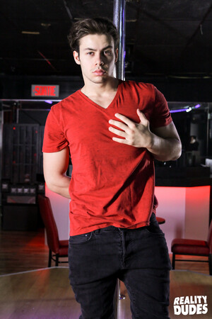 Young handsome Philippe gets naked and dances on a pole with his big cock